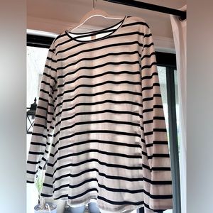 Long sleeved, black and white striped shirt, elbow patches.